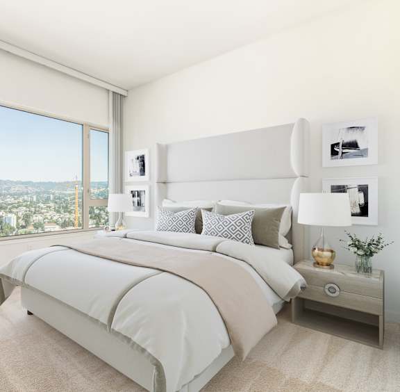 A bedroom with a large bed and a chair by the window. at The Grand Apartments, Oakland, CA, 94612